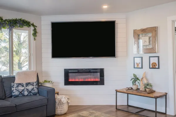 a living room with furniture and a flat screen tv