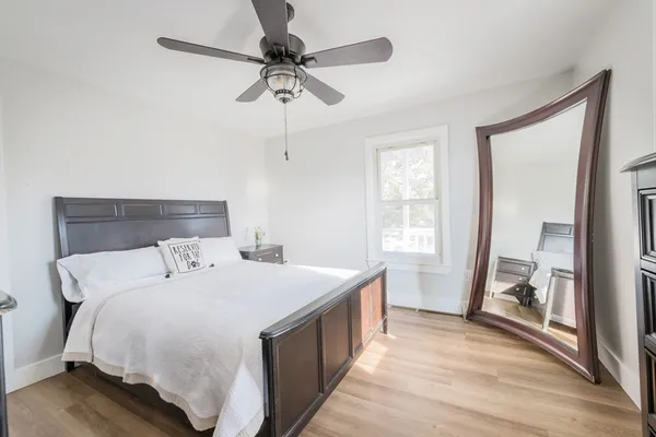 a bedroom with a bed and a chandelier