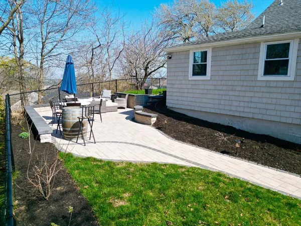 a view of a patio with table and chairs with wooden fence