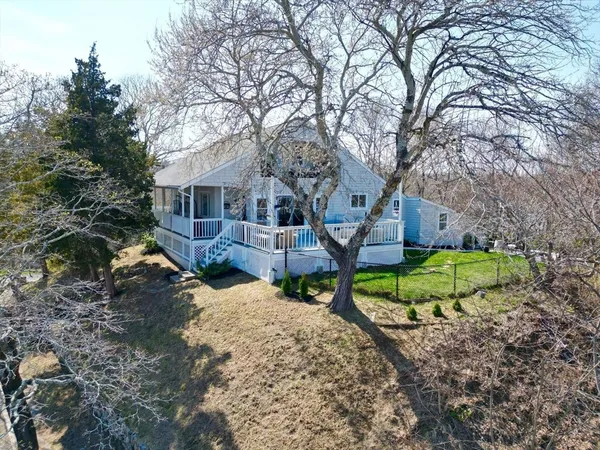 a view of a house with backyard and sitting area