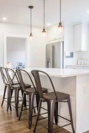 a dinning room filled with furniture and wooden floor