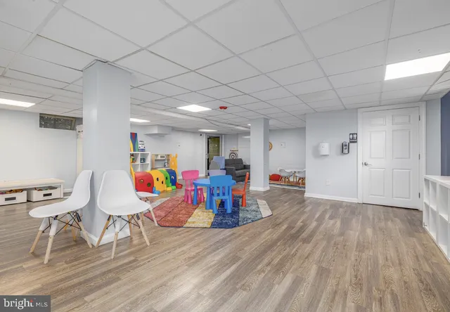 a view of a room with furniture and wooden floor