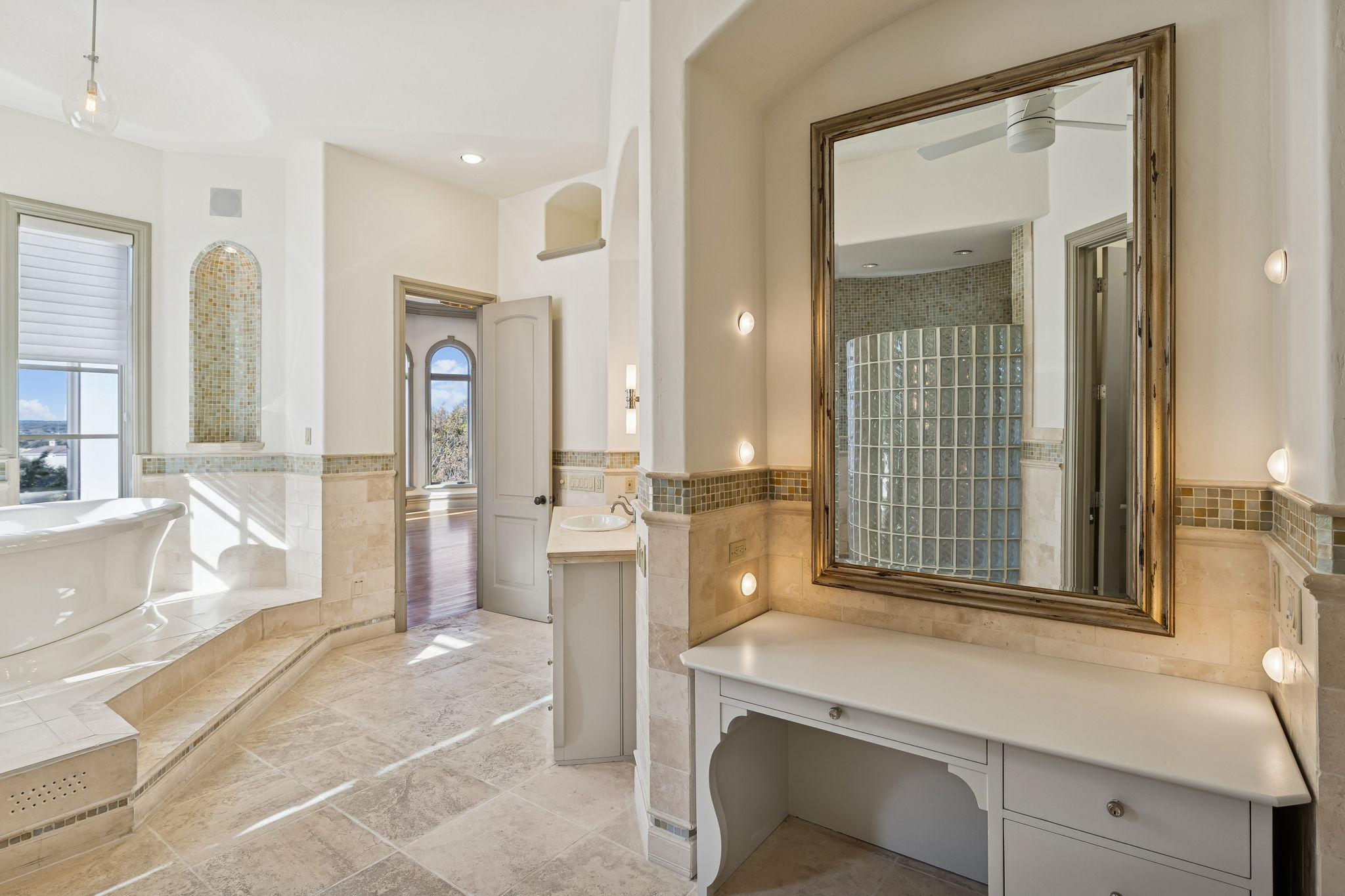 16010 Canard Circle Austin, TX 78734 - Photo 15 of 35 a bathroom with a tub a sink a mirror and a shower