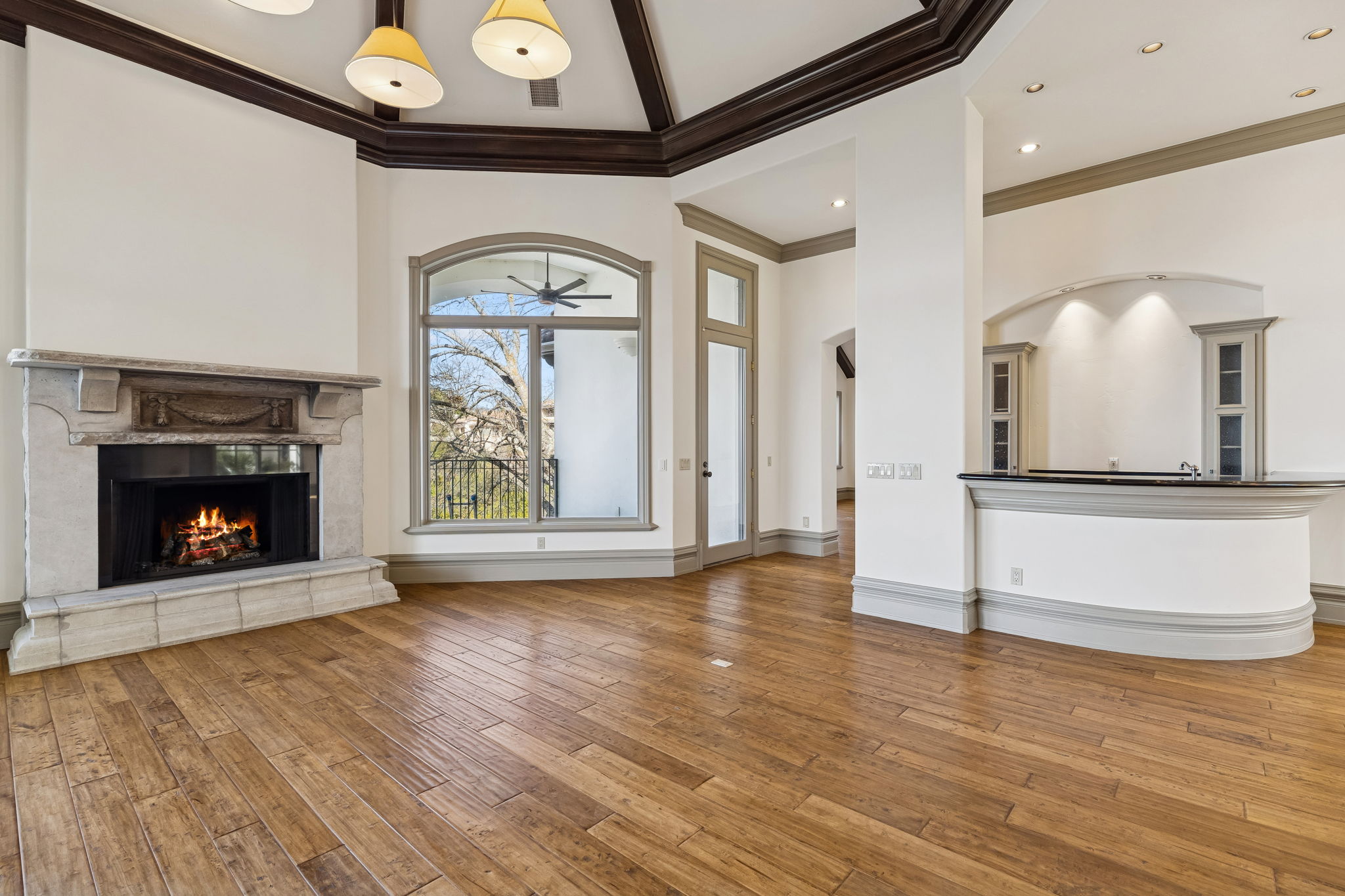 16010 Canard Circle Austin, TX 78734 - Photo 5 of 35 a view of a hallway with wooden floor a fireplace and a window