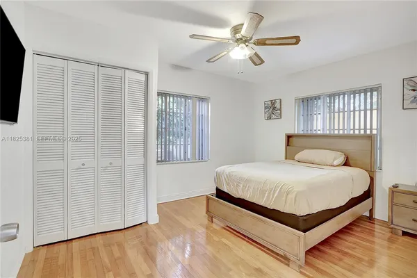 a bedroom with a large bed and a chandelier