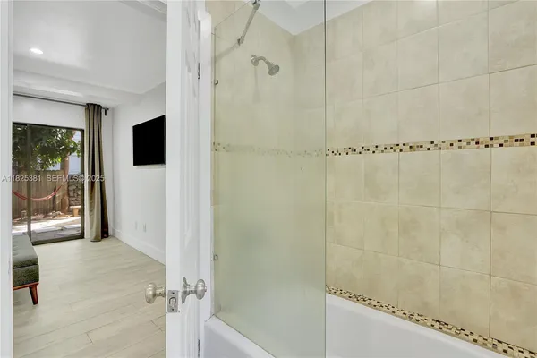 a bathroom with a shower and a glass door