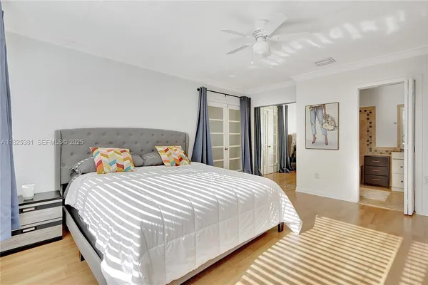 a bedroom with a bed and a chandelier