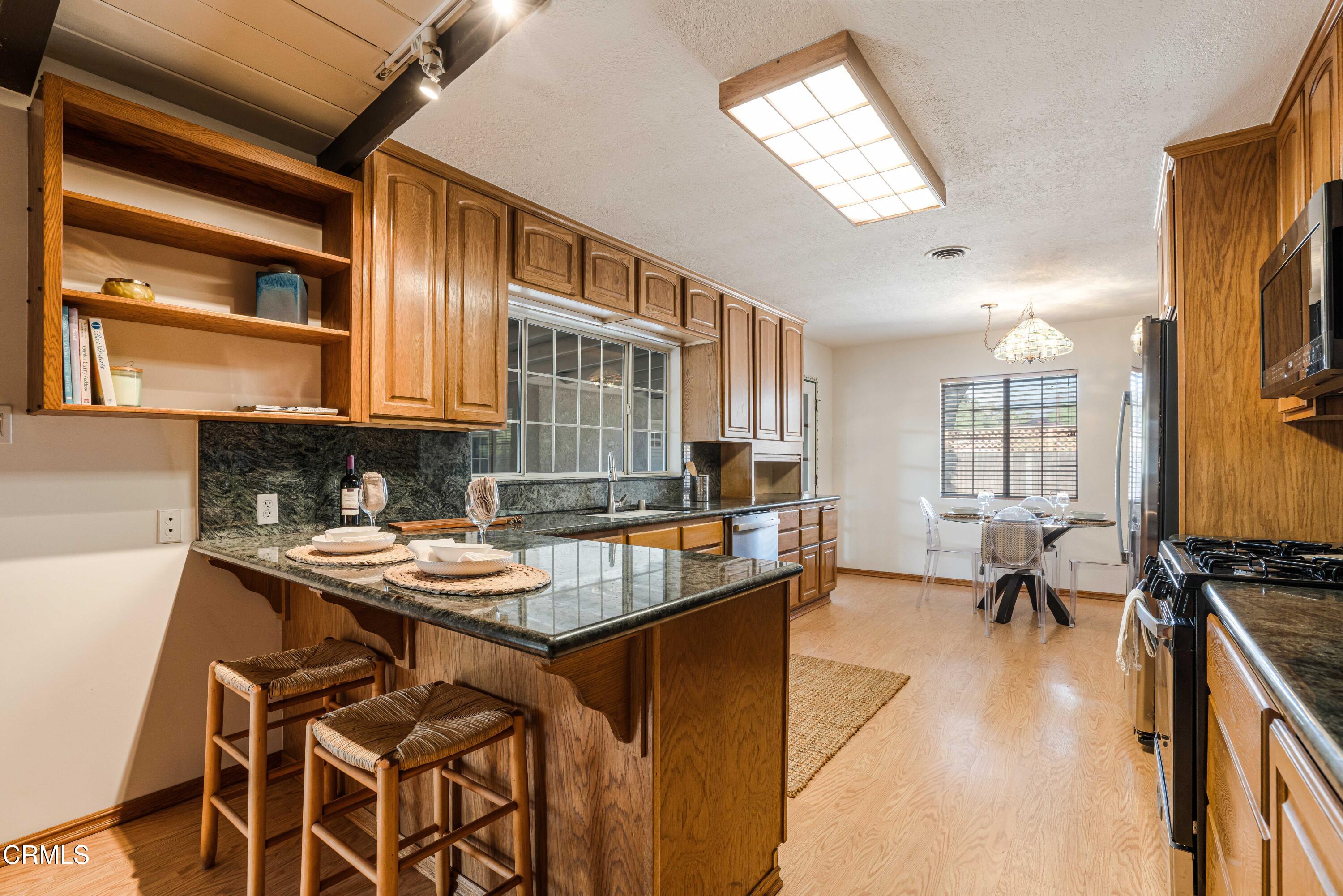 467 Riverside Road Oak View, CA 93022 - Photo 14 of 65 a kitchen with a table chairs stove and cabinets