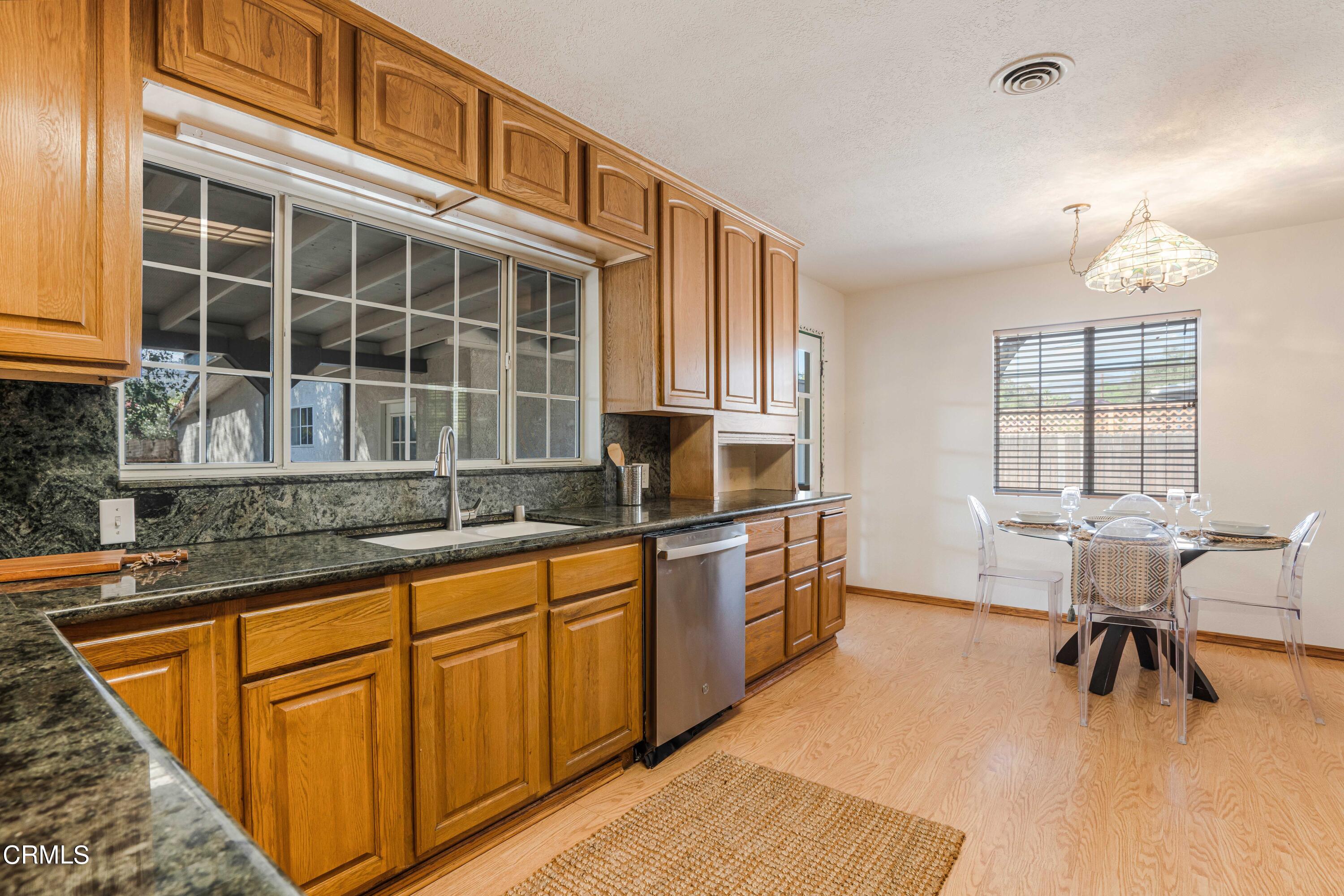 467 Riverside Road Oak View, CA 93022 - Photo 15 of 65 a kitchen with stainless steel appliances granite countertop sink stove and wooden cabinets