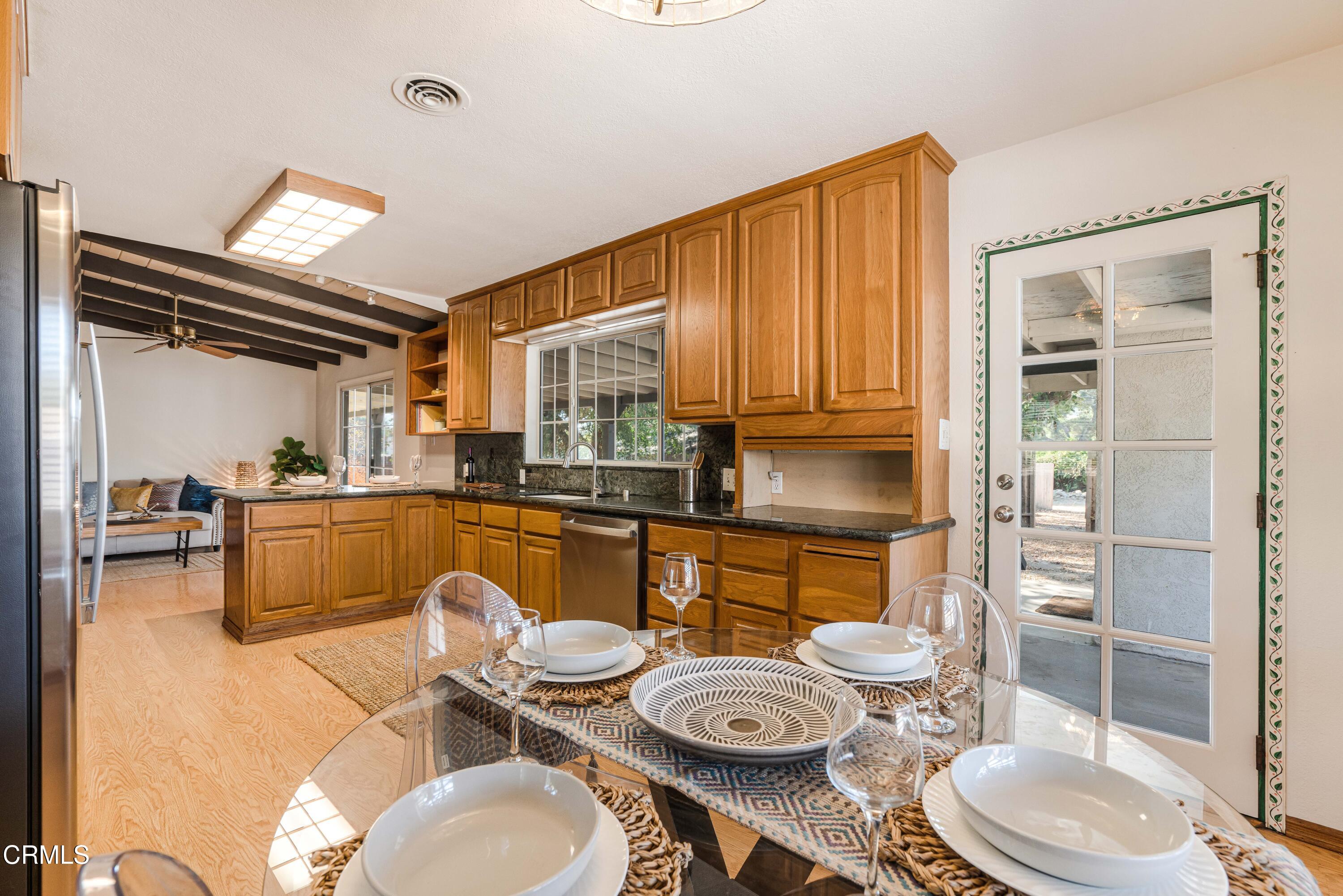 467 Riverside Road Oak View, CA 93022 - Photo 16 of 65 a kitchen with granite countertop lots of appliances and wooden floor