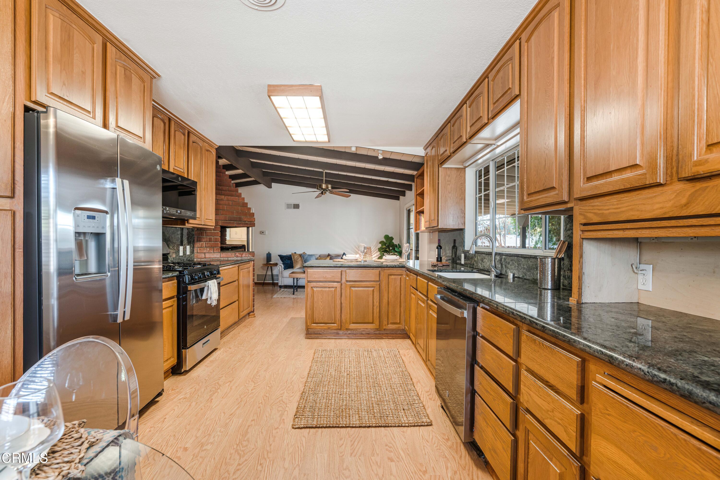 467 Riverside Road Oak View, CA 93022 - Photo 17 of 65 a kitchen with stainless steel appliances granite countertop a sink and wooden cabinets
