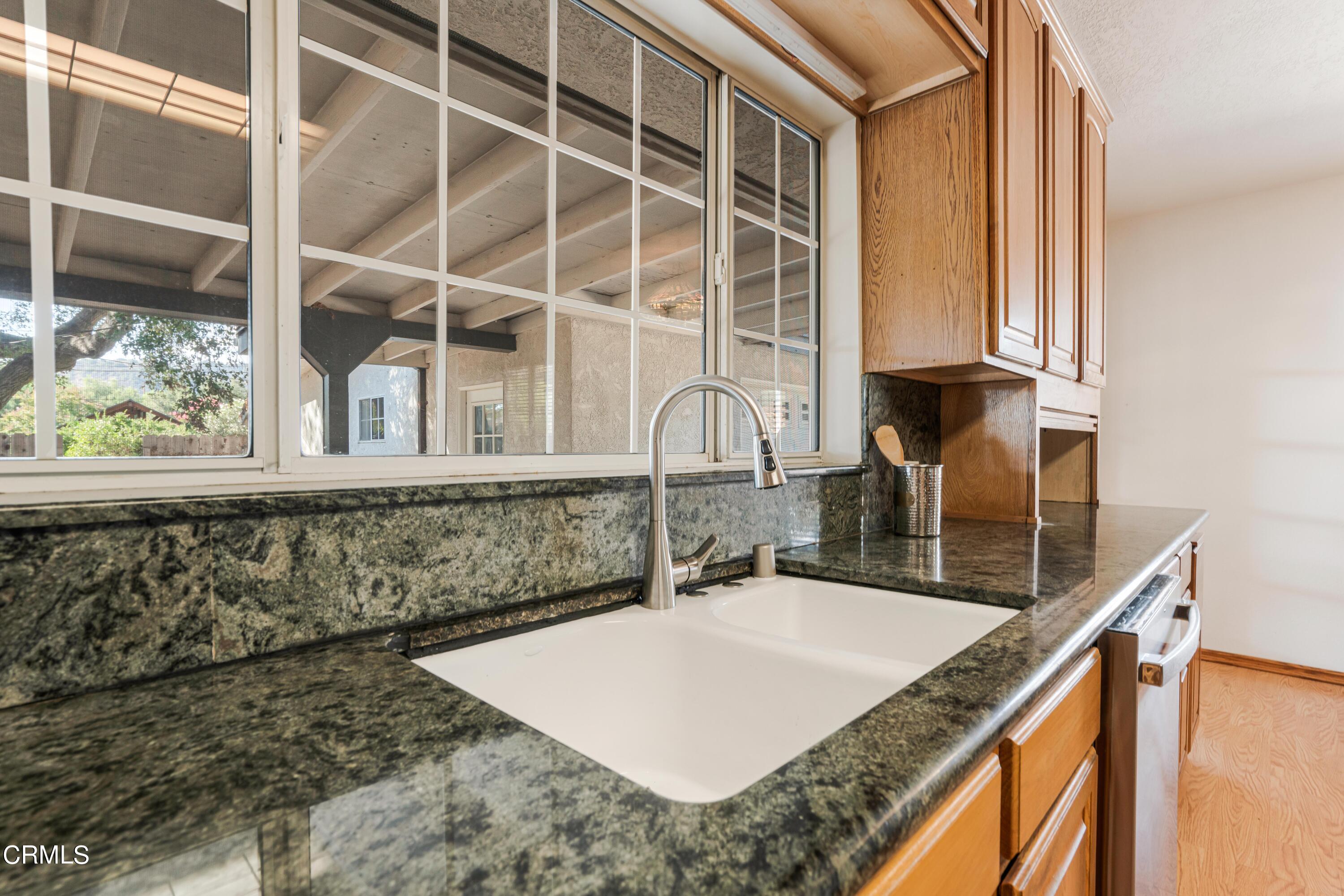 467 Riverside Road Oak View, CA 93022 - Photo 19 of 65 a kitchen with a granite countertop sink and a window