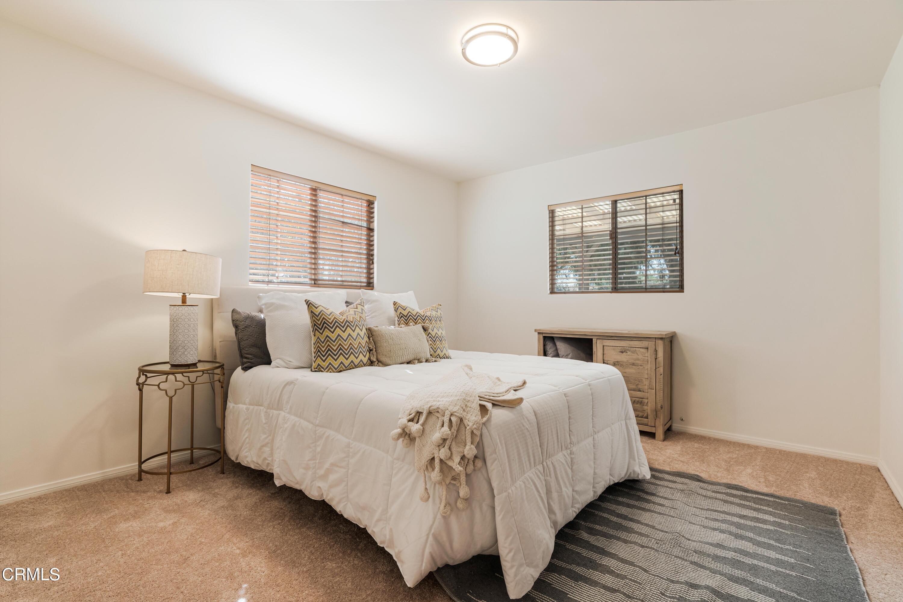 467 Riverside Road Oak View, CA 93022 - Photo 24 of 65 a bedroom with a bed and a window