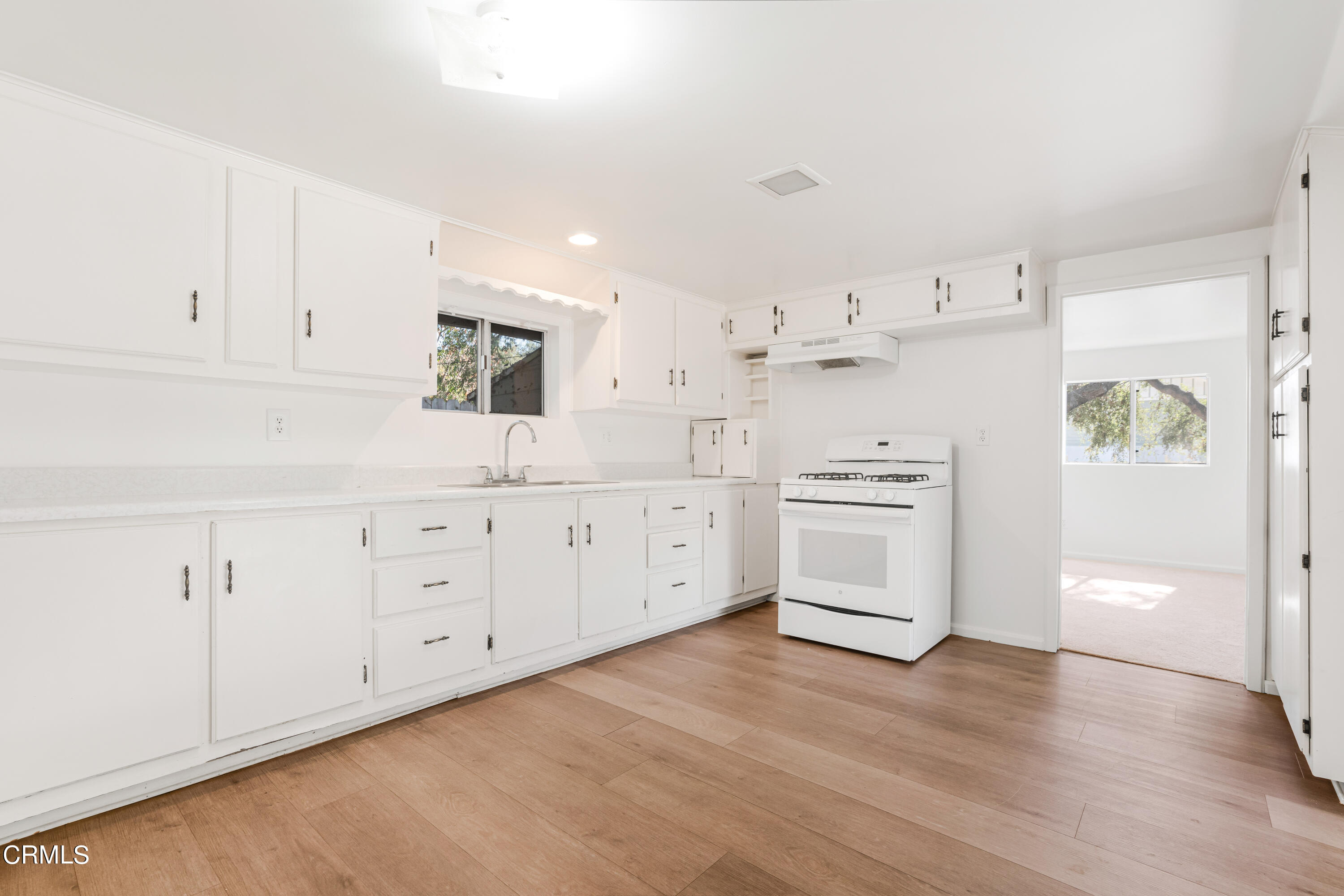 467 Riverside Road Oak View, CA 93022 - Photo 37 of 65 a kitchen with cabinets stainless steel appliances and wooden floor