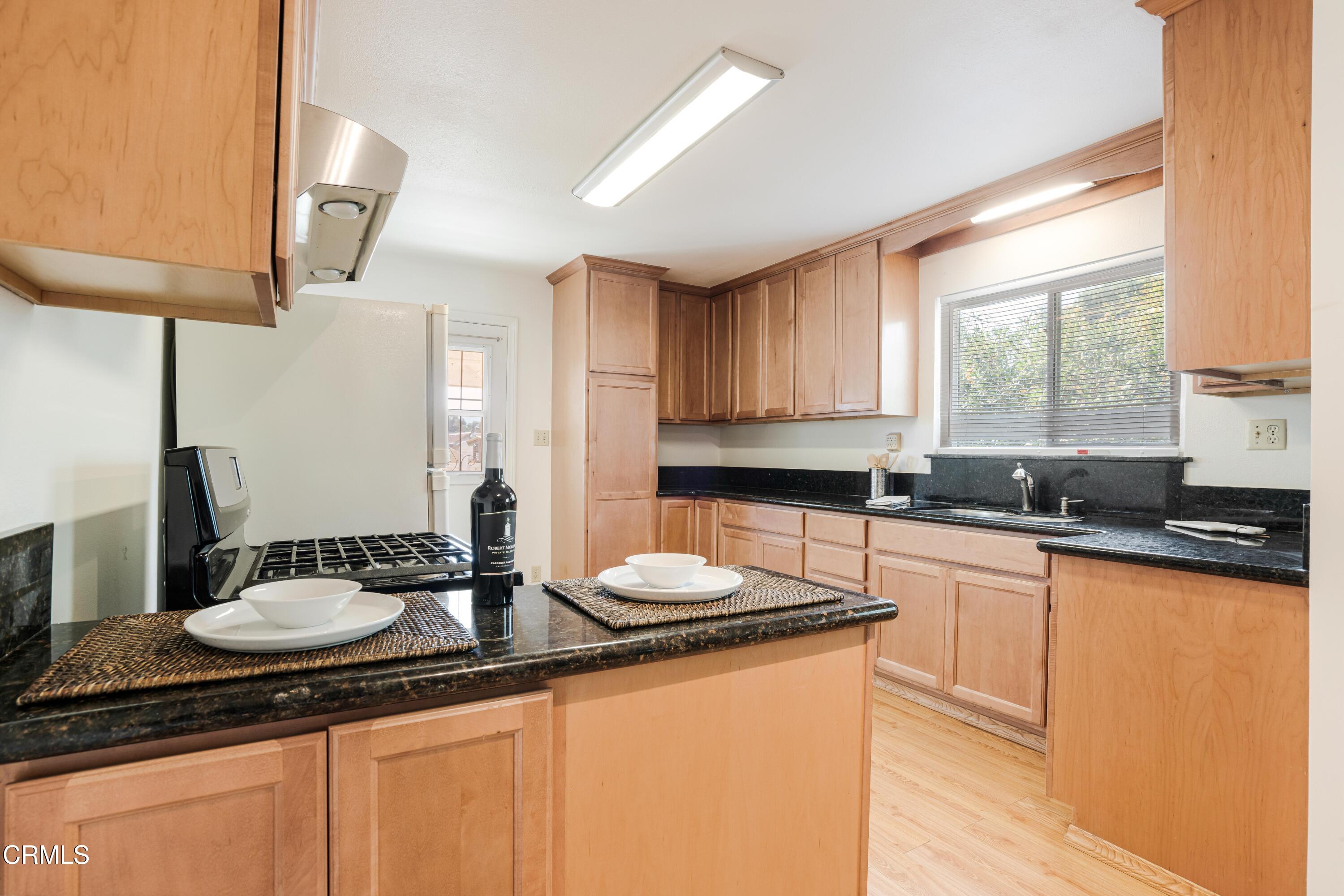 467 Riverside Road Oak View, CA 93022 - Photo 47 of 65 a kitchen with stainless steel appliances granite countertop a sink a stove and a wooden cabinets