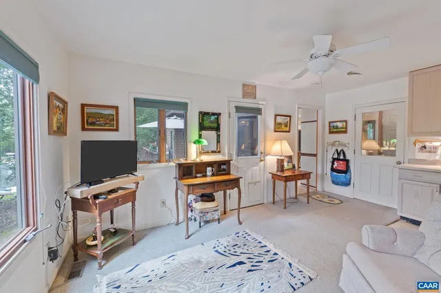 a bedroom with a bed and large windows