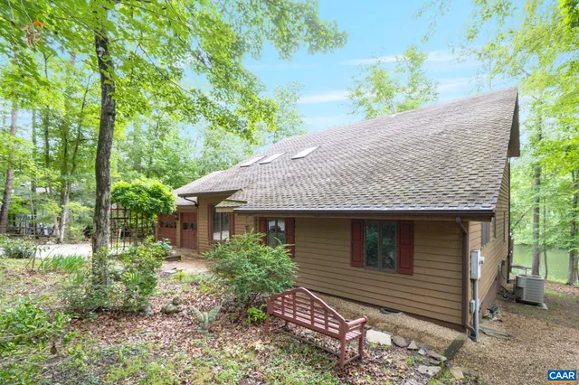 a backyard of a house with yard and outdoor seating