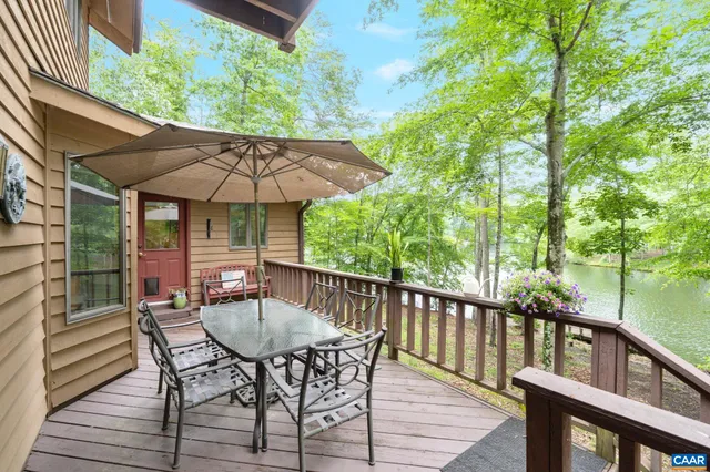 a view of house with backyard and sitting area