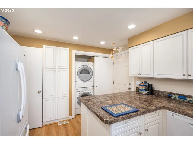 a kitchen with a sink a refrigerator and a stove
