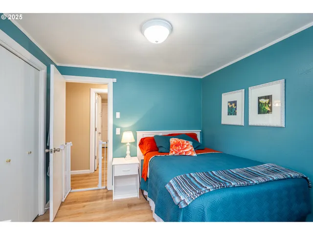 a bedroom with a bed and a painting on the wall