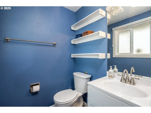 a bedroom with a bed and a night stand