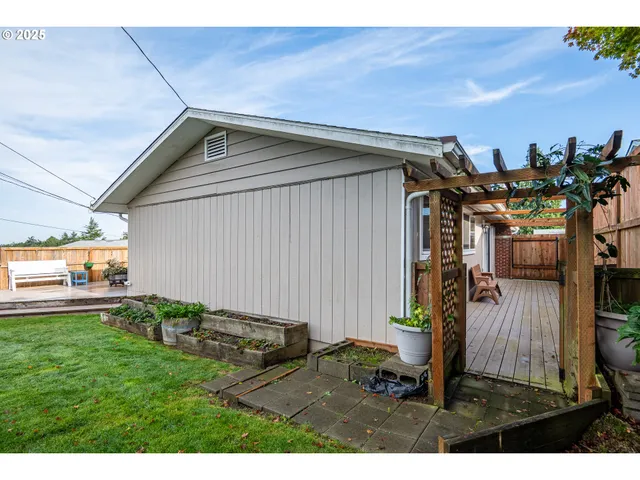 a view of a backyard with plants and a garden