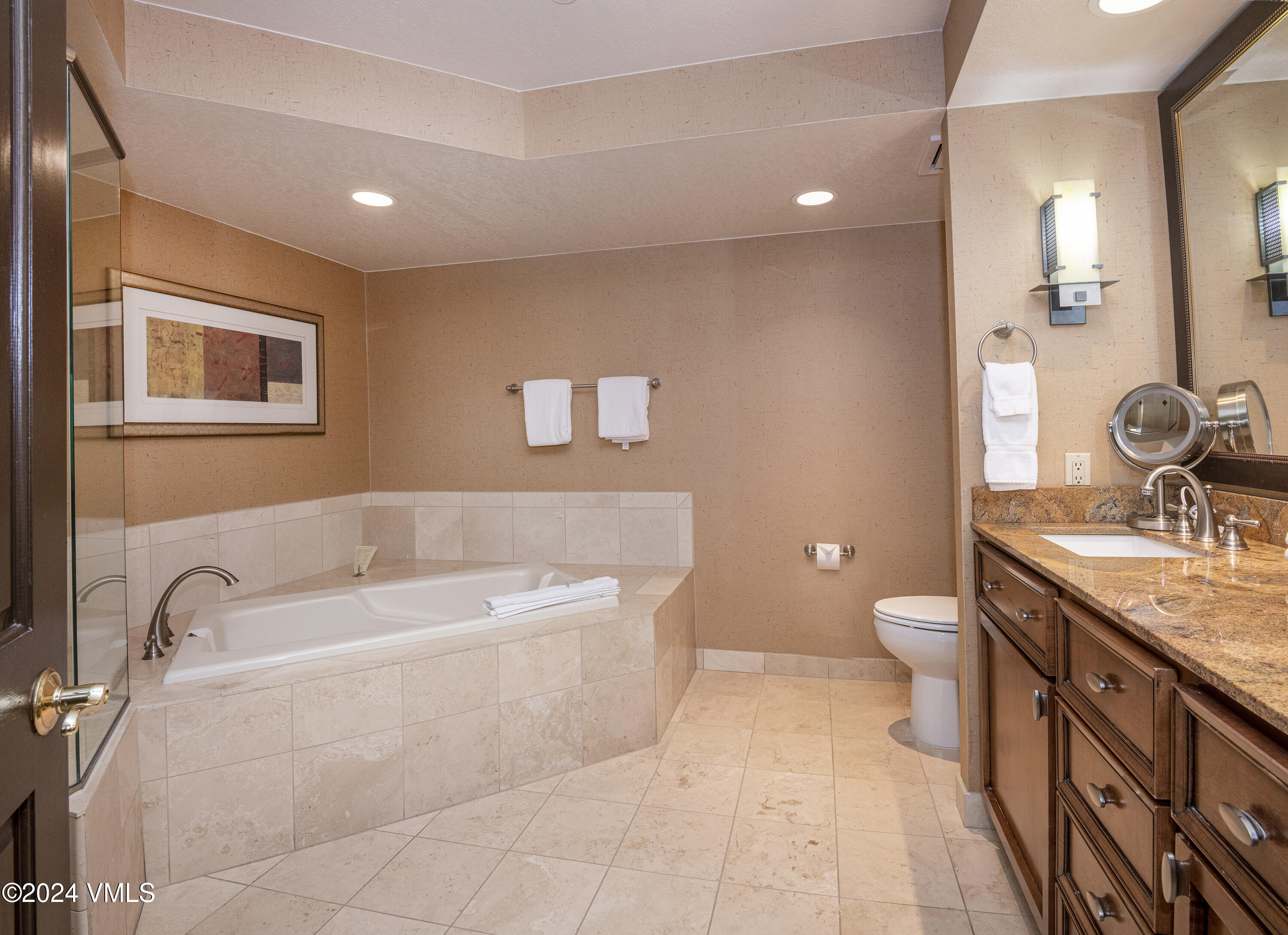 210 Offerson Road, Unit 3052 Beaver Creek, CO 81620 - Photo 6 of 10 a spacious bathroom with a granite countertop sink a toilet and mirror