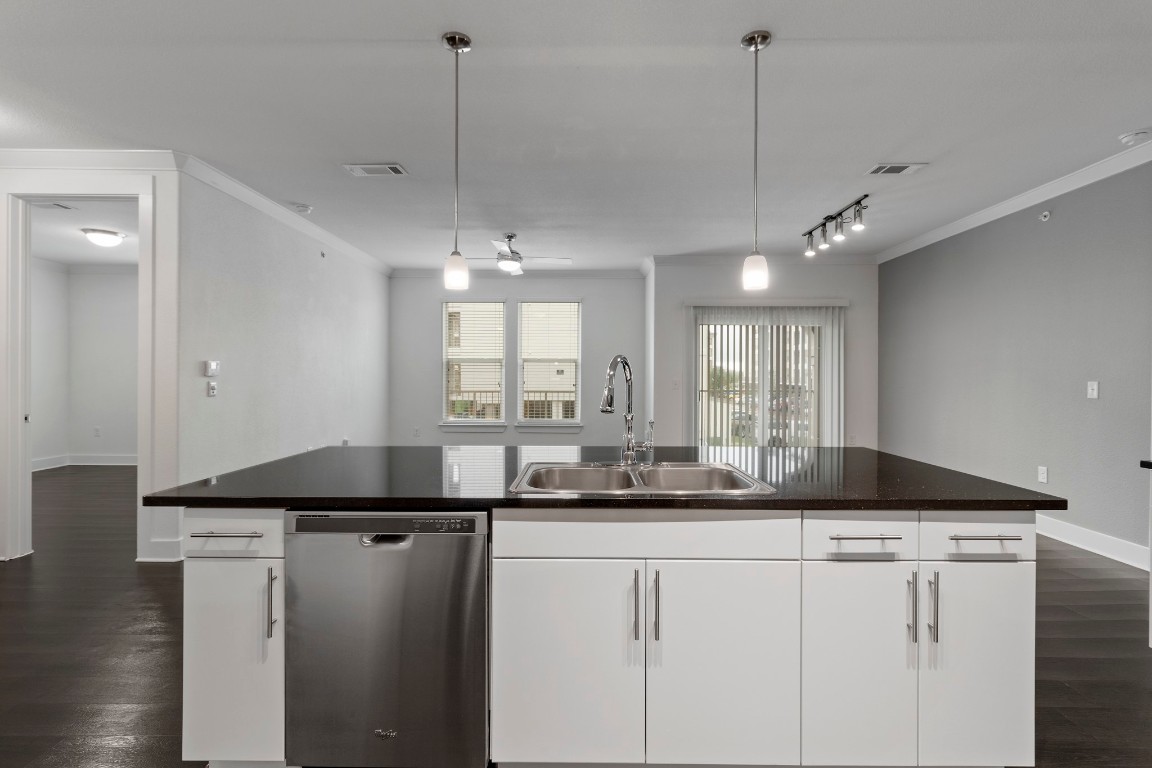 3300 Towers Boulevard, Unit 958 Seabrook, TX 77586 - Photo 13 of 33 a kitchen with kitchen island granite countertop a sink a counter space appliances and cabinets