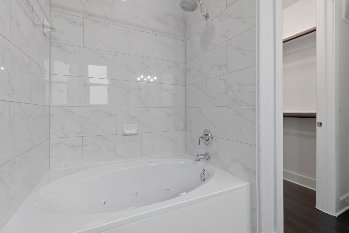 3300 Towers Boulevard, Unit 958 Seabrook, TX 77586 - Photo 19 of 33 a close up of a bathtub in a bathroom