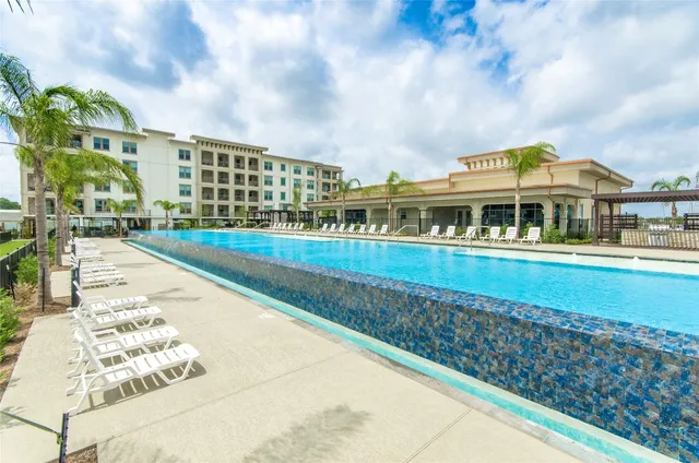 a view of swimming pool with buildings in the background
