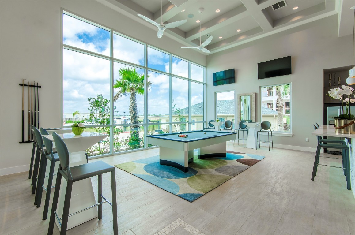 3300 Towers Boulevard, Unit 958 Seabrook, TX 77586 - Photo 27 of 33 a dining room with furniture and large windows
