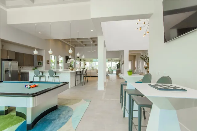 a living room with dining table and chairs