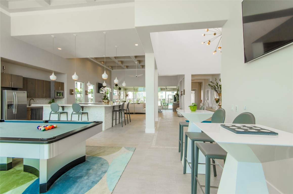 3300 Towers Boulevard, Unit 958 Seabrook, TX 77586 - Photo 28 of 33 a living room with dining table and chairs