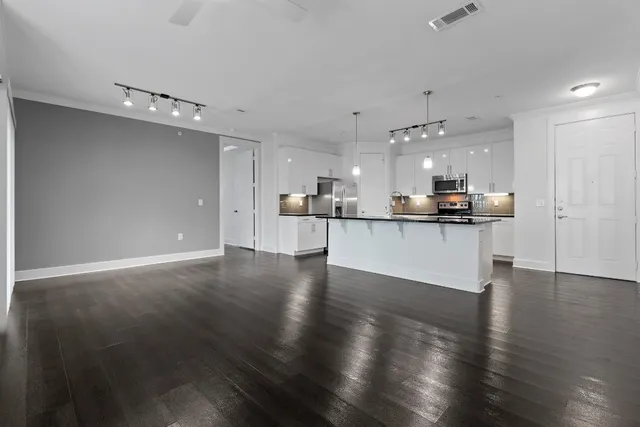 a view of a kitchen with a sink wooden floor and a window