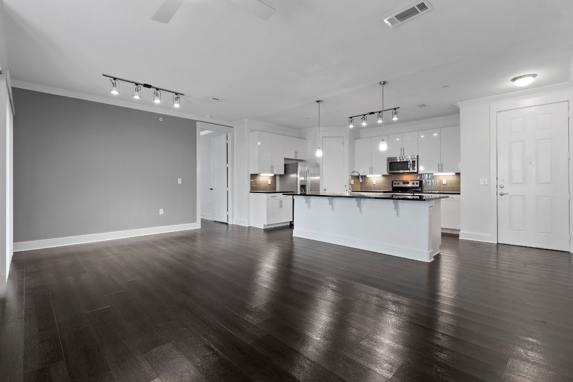 3300 Towers Boulevard, Unit 958 Seabrook, TX 77586 - Photo 4 of 33 a view of a kitchen with a sink wooden floor and a window