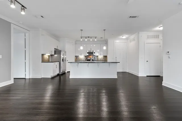 a view of a kitchen with stove and wooden floor