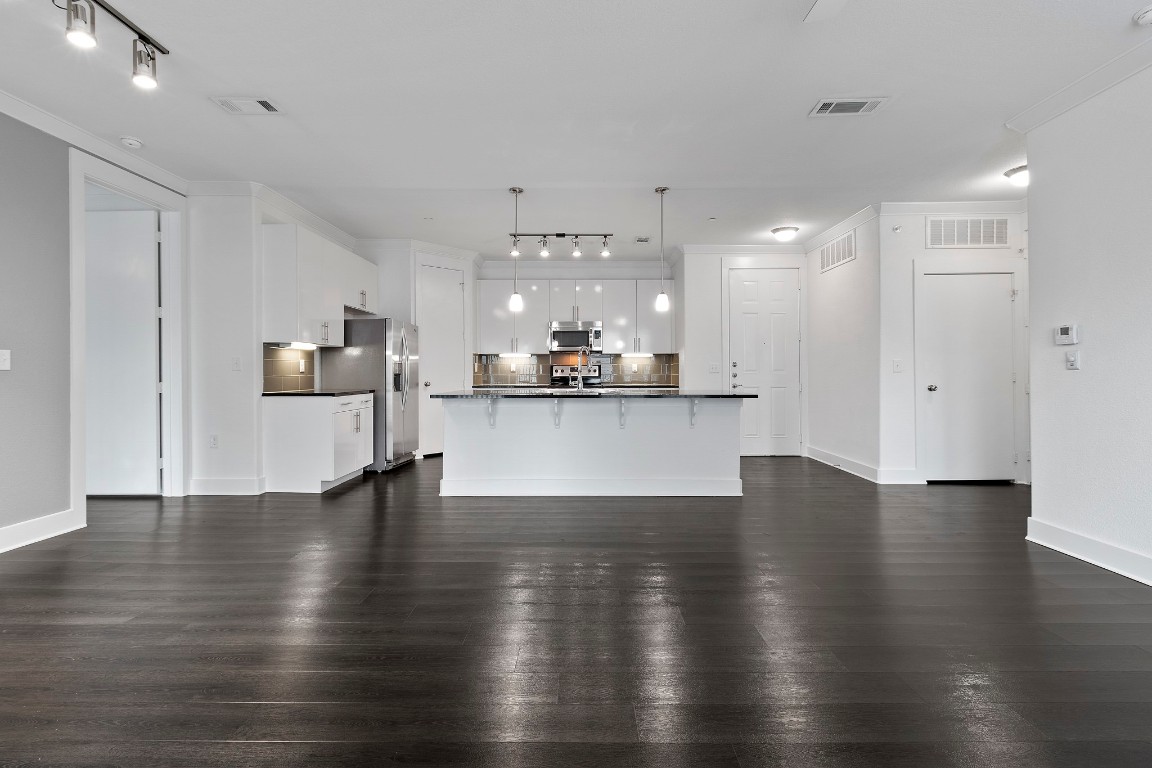 3300 Towers Boulevard, Unit 958 Seabrook, TX 77586 - Photo 5 of 33 a view of a kitchen with stove and wooden floor