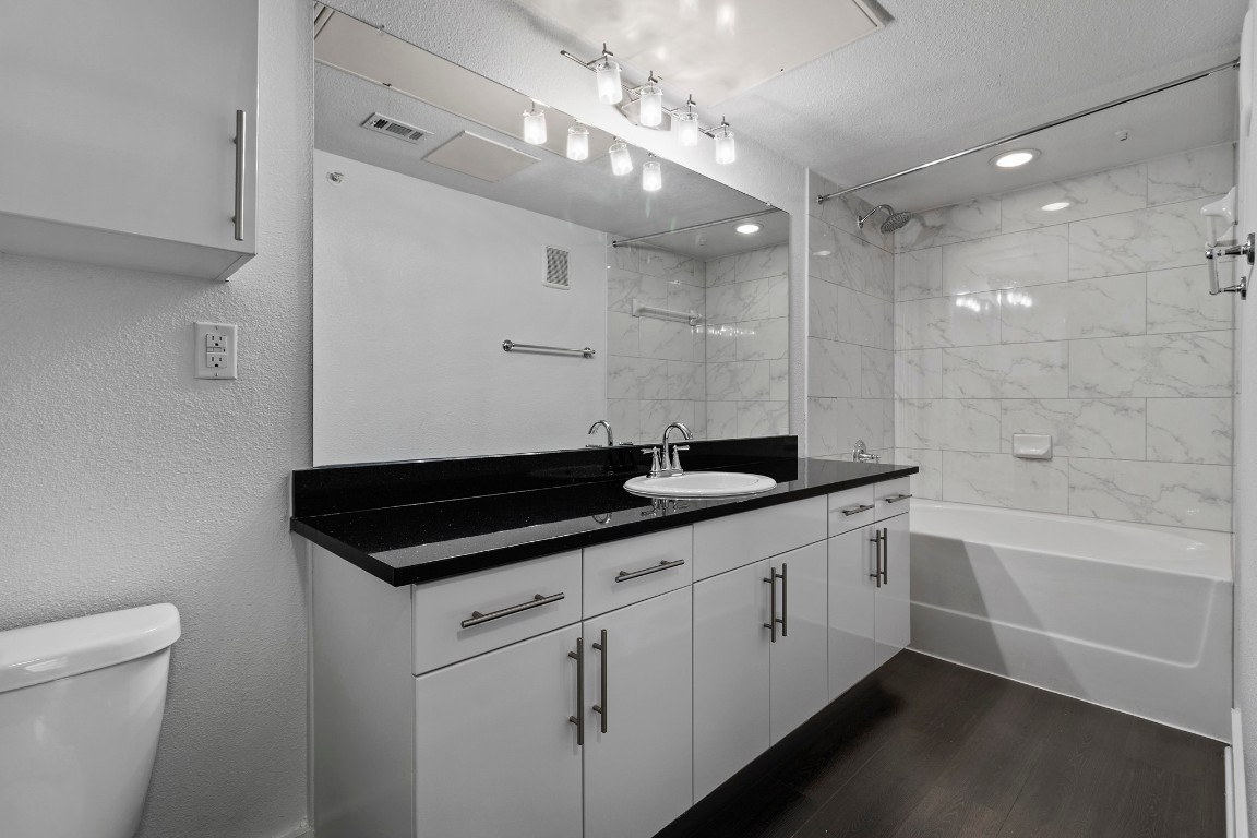 3300 Towers Boulevard, Unit 958 Seabrook, TX 77586 - Photo 6 of 33 a bathroom with a sink a large mirror and a toilet