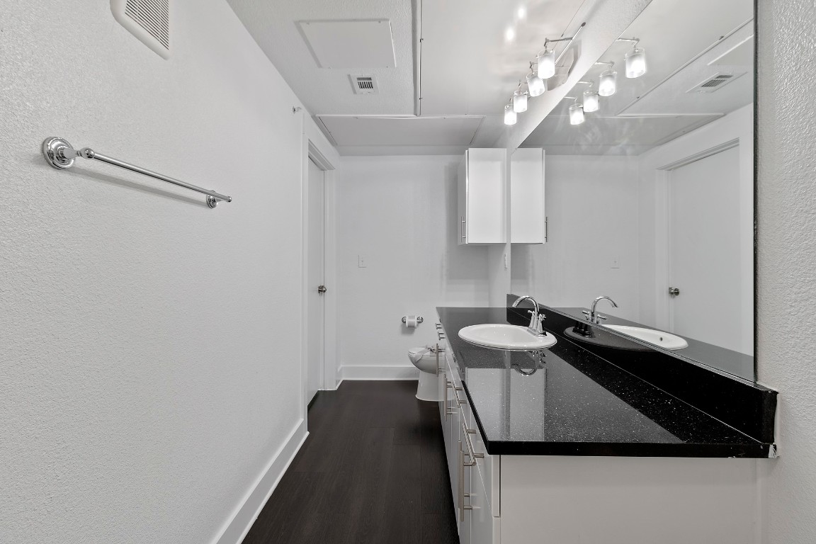 3300 Towers Boulevard, Unit 958 Seabrook, TX 77586 - Photo 7 of 33 a kitchen with a sink dishwasher and a stove with wooden floor