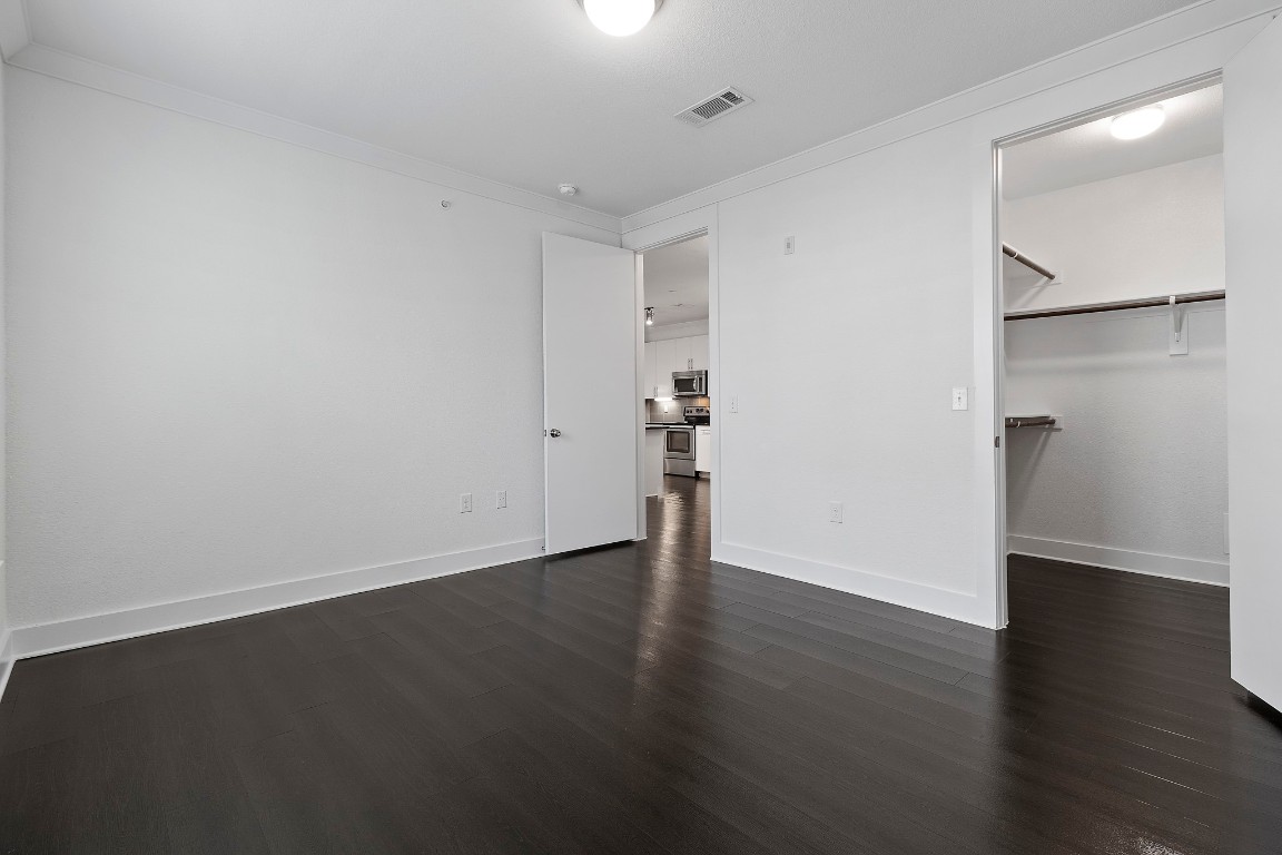 3300 Towers Boulevard, Unit 958 Seabrook, TX 77586 - Photo 10 of 33 a view of an empty room with wooden floor and a window