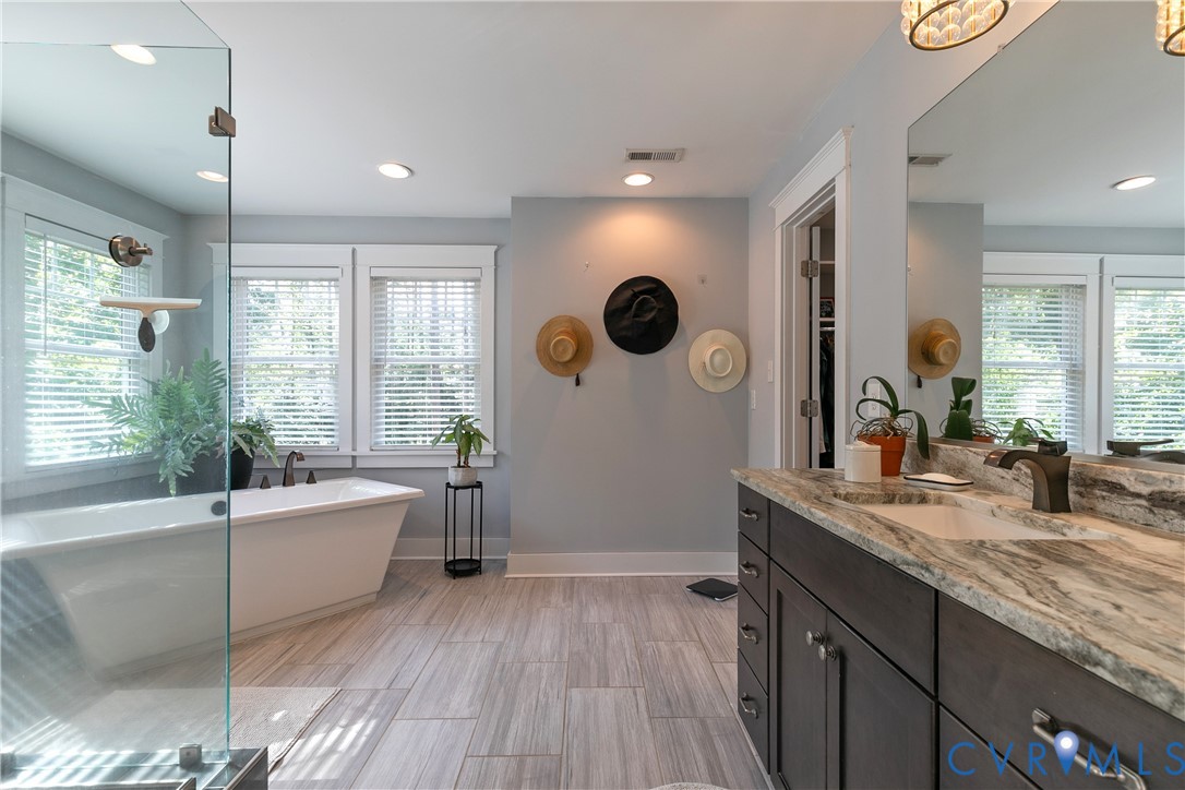 9749 Hoke Brady Road Henrico, VA 23231 - Photo 30 of 53 a spacious bathroom with sinks mirror and a bathtub