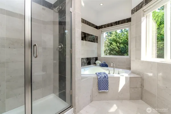 a bathroom with a bathtub and a shower