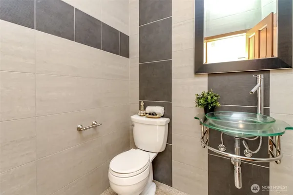 a bathroom with a toilet a sink and a window