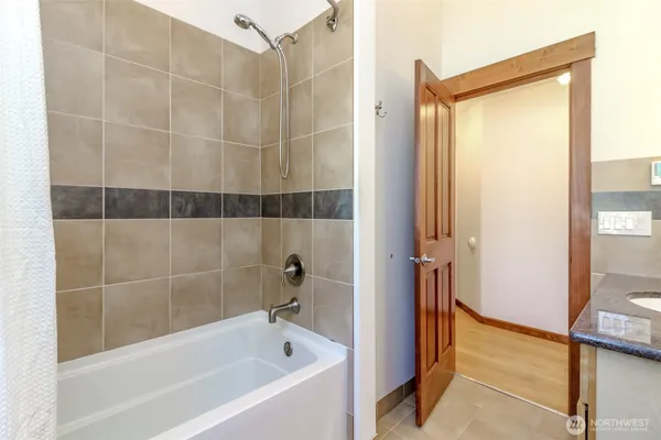 a bathroom with a bathtub and a shower