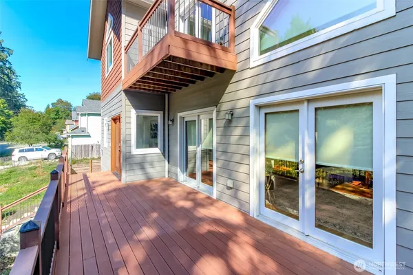 a view of a porch with wooden floor and fence