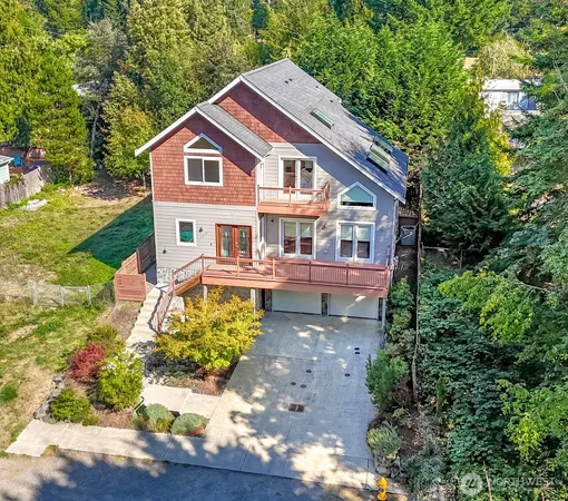 a aerial view of a house with a yard table and chairs