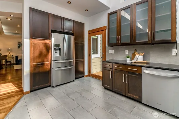 a kitchen with stainless steel appliances granite countertop a refrigerator and a sink