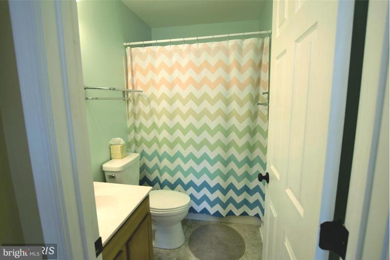 403 McDaniel Drive Purcellville, VA 20132 - Photo 11 of 13 a bathroom with a toilet and a shower curtain