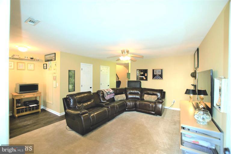 403 McDaniel Drive Purcellville, VA 20132 - Photo 12 of 13 a living room with furniture and a flat screen tv
