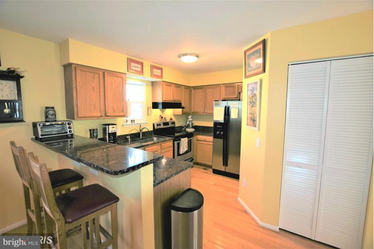 403 McDaniel Drive Purcellville, VA 20132 - Photo 2 of 13 a kitchen with granite countertop lots of counter top space and stainless steel appliances